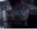...and examines a snow globe, reminiscent of his mother...