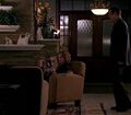 Sandra and Mr. Bennet talk in the living room of the Bennets' home.