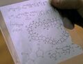 Hiro looks at the formula his father gave him.