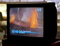 The wreck is on the news in Isaac's apartment.