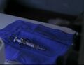 A hypodermic needle of the virus is prepared, intended for use on Maury Parkman.