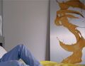 As a yellow painting in Erica's home. (11:53 to Odessa)