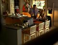 Claire and her father share secrets and orange juice in their kitchen.