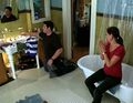 Janice watches as Matt fixes the bathroom sink.