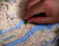...and she places a pushpin on a map. (How to Stop an Exploding Man)