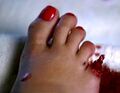 Claire cuts off her toe, which then grows back, much to Claire's surprise. (Lizards)