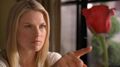 Tracy begins to freeze a rose in her apartment.